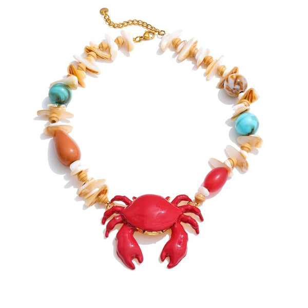 Gold-plated necklace with red crab pendant and turquoise stones.