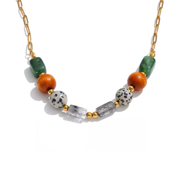 piece of jewelry with gold chain, featuring natural stone beads in shades of green, red, and blue, along with resin beads, all set against a white background.