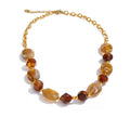 Gold-plated stainless steel necklace with resin beads featuring amber and brown stones.