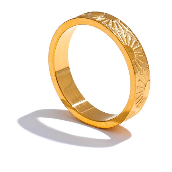 Gold-plated stainless steel ring with a carved design on top.